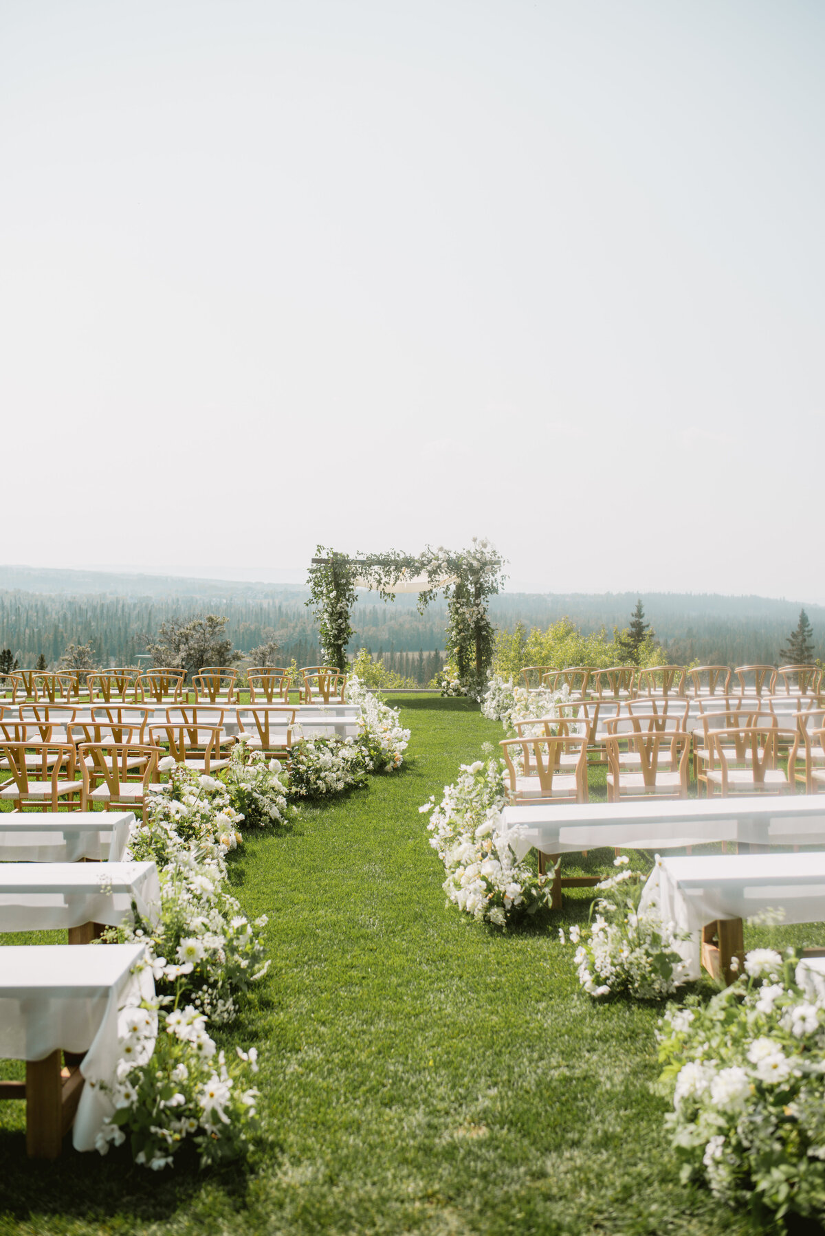 Summer wedding Ceremony at Pinebrook Golf Club, meadow aisle florals and luxury design aesthetic