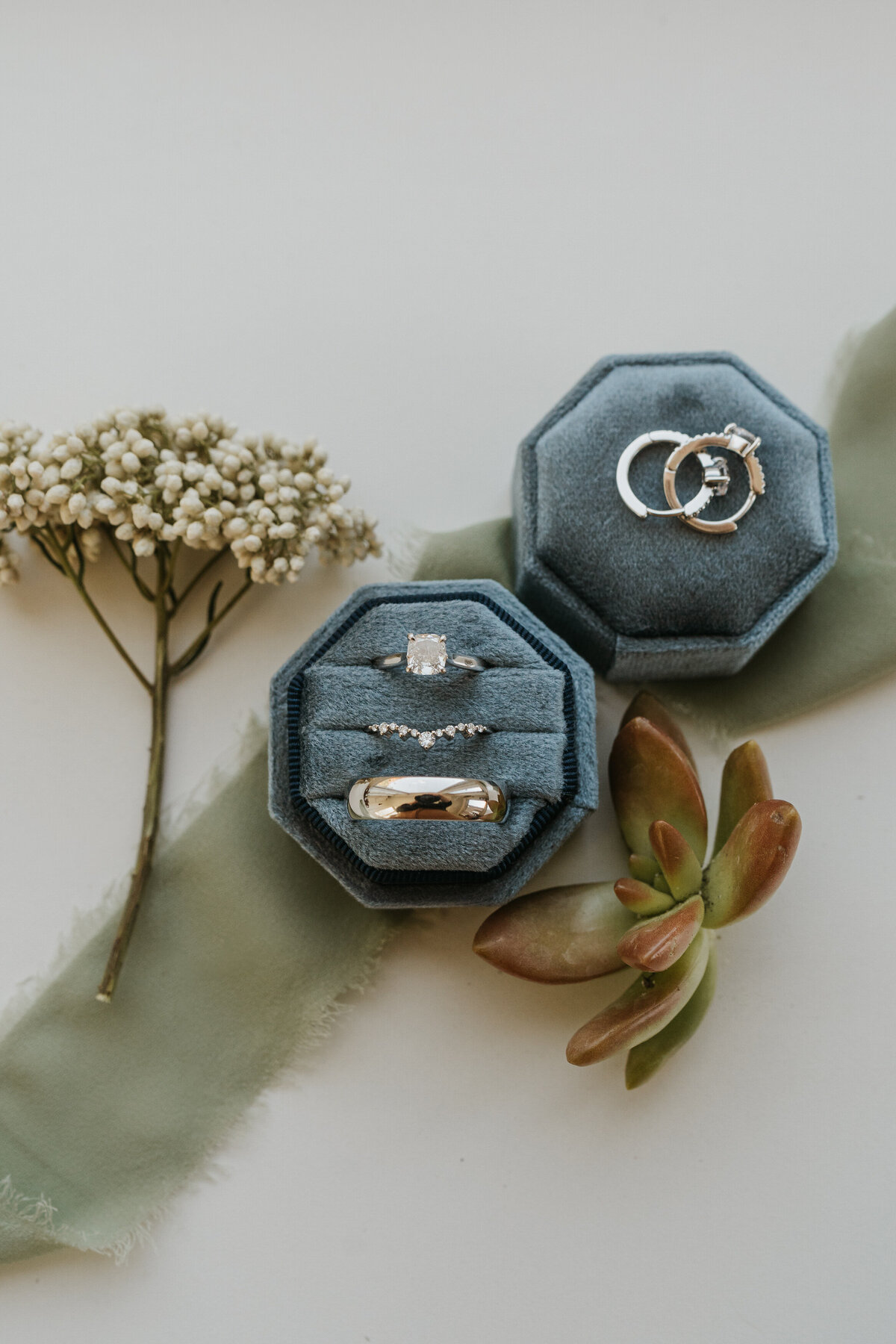 Two ring boxes with wedding and engagement bands