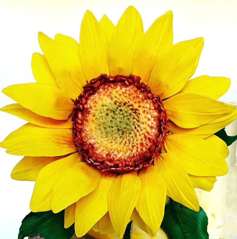 Large yellow sugar flower sunflower with orange center accents