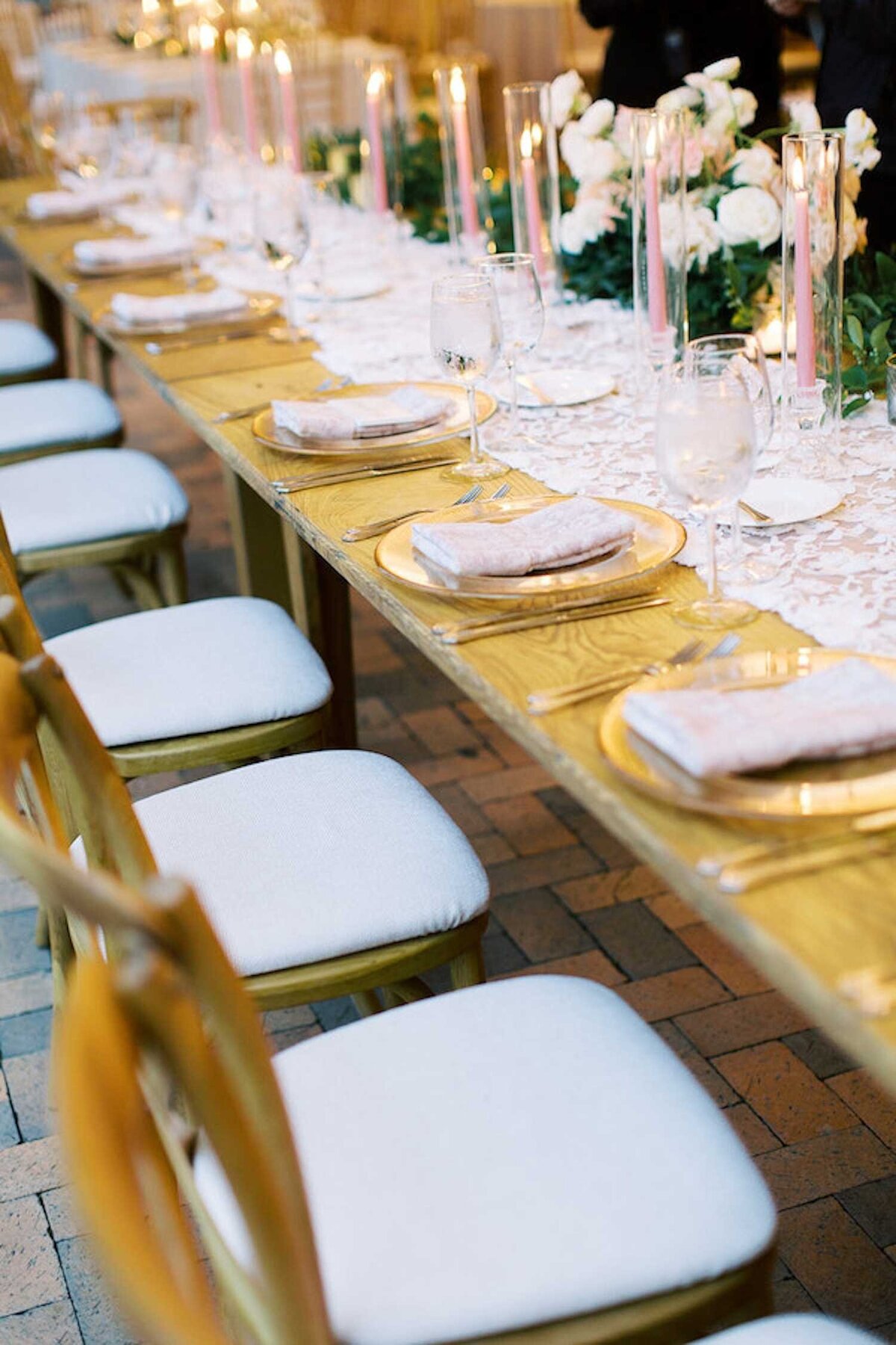 Romantic lace table runner and elegant placesettings at a head table during a luxury Chicago outdoor garden wedding.