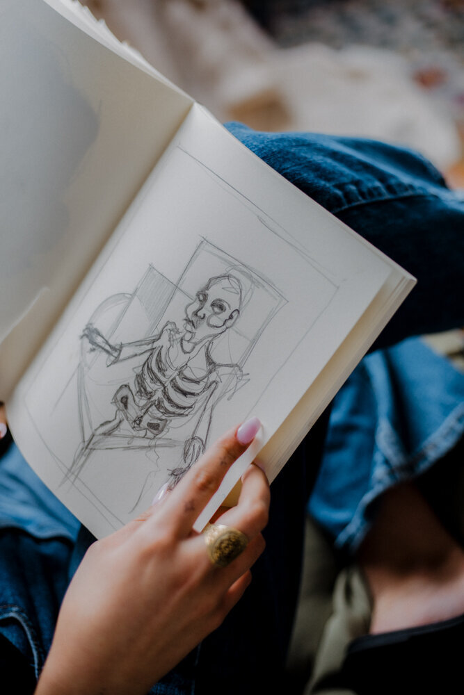an artist with her sketchbook