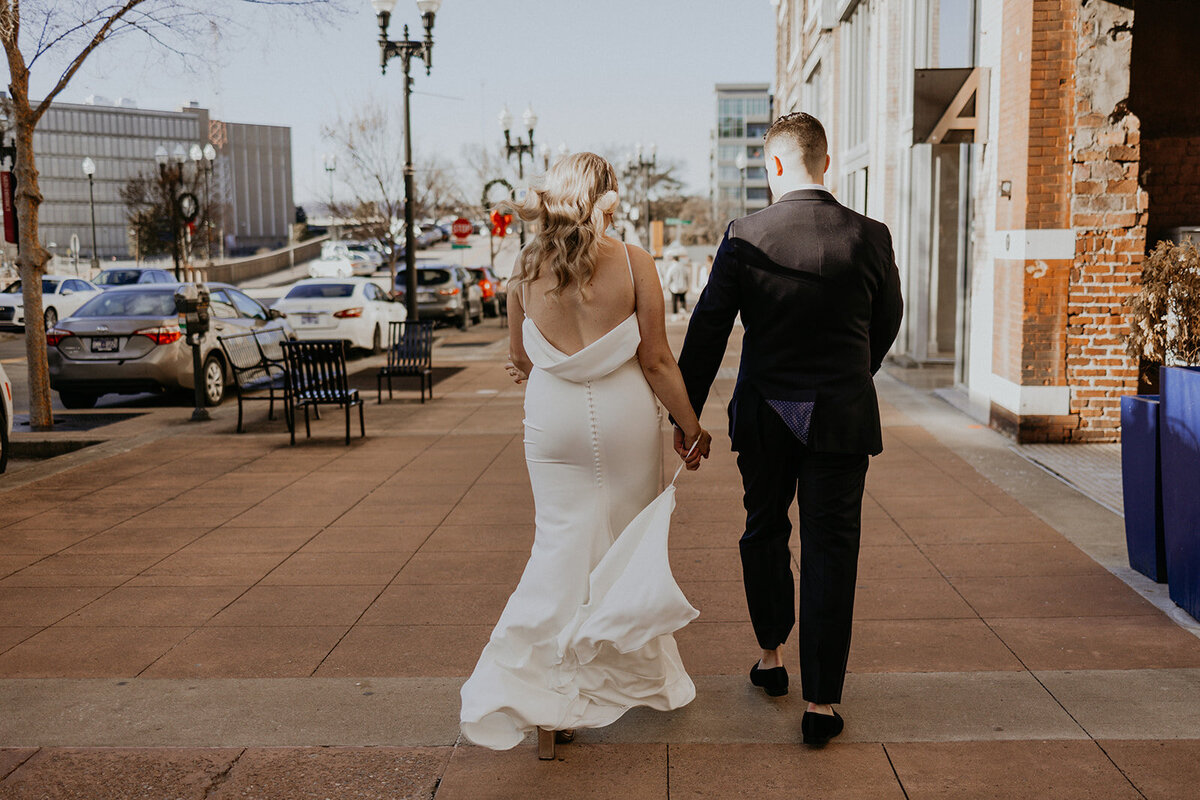 bride and groom walking in downtown  Knoxville