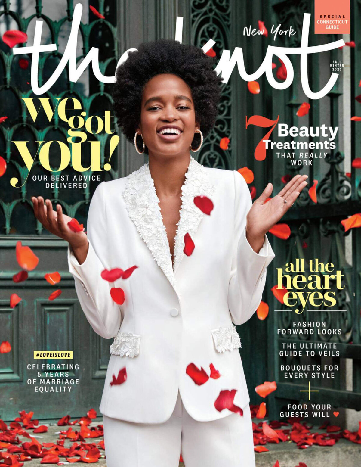 An image of a bride, wearing a bridal suit, with red leaves falling, in The Knot Magazine cover. Image by Jenny Fu Studio