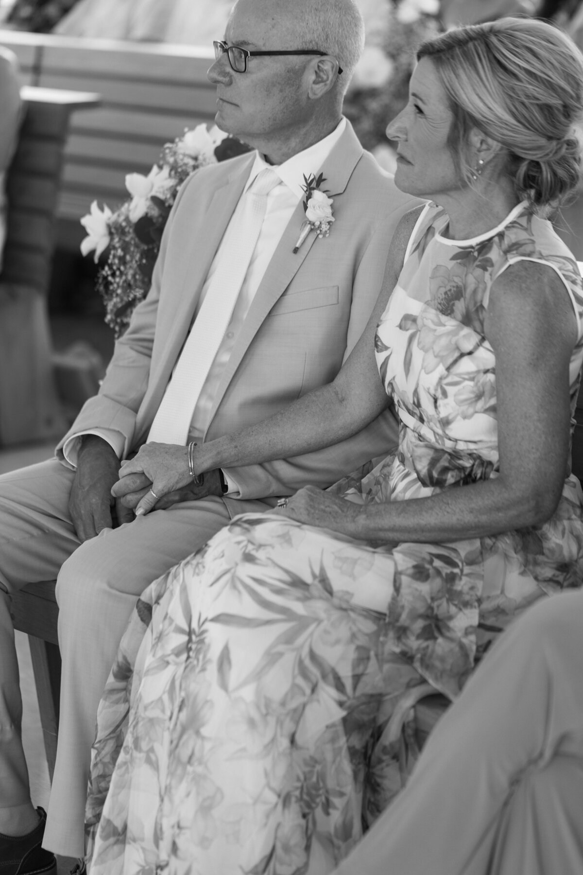 Bride's parents hold hands during Cancun wedding ceremony, photo by Philadelphia wedding photographer.