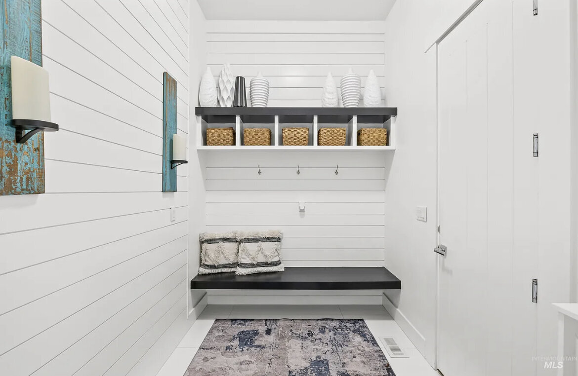 mudroom with seating bench  and shelves