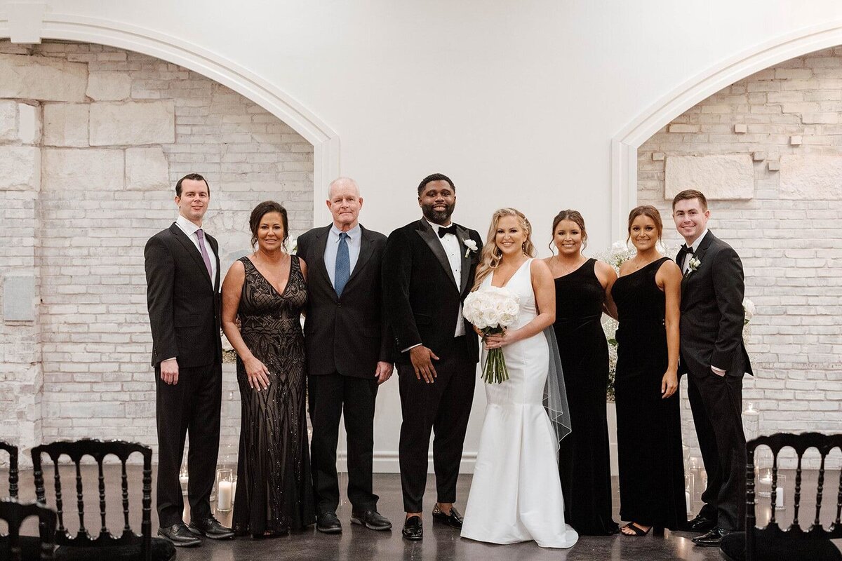 Bride and groom with family in unique STL wedding venue