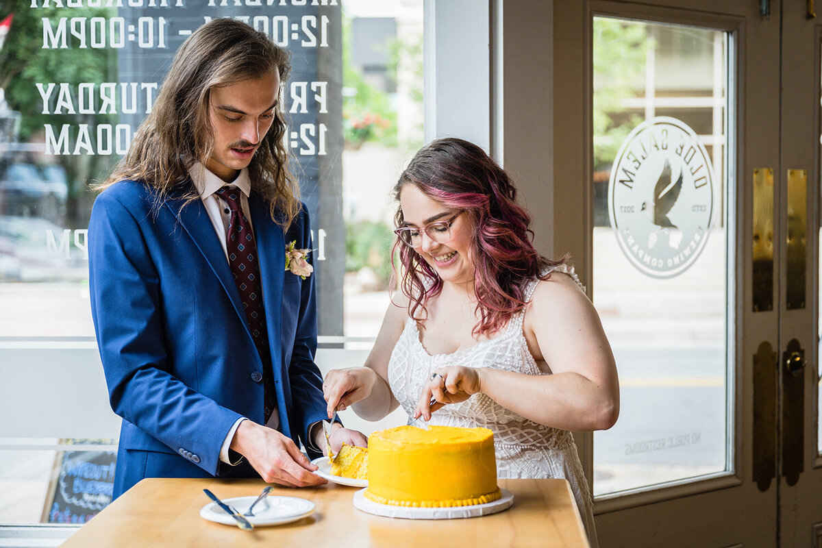 A marrier serves a slice of cake to her partner in Olde Salem Brewery in Downtown Roanoke on their elopement day.