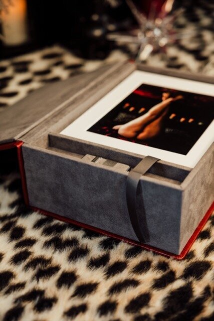 Boudoir photography image box with red cover on leopard rug in Lubbock, Texas photographer in Amarillo TX