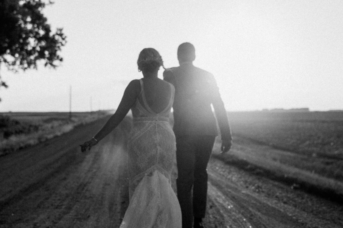 couple-walking-on-dirt-road
