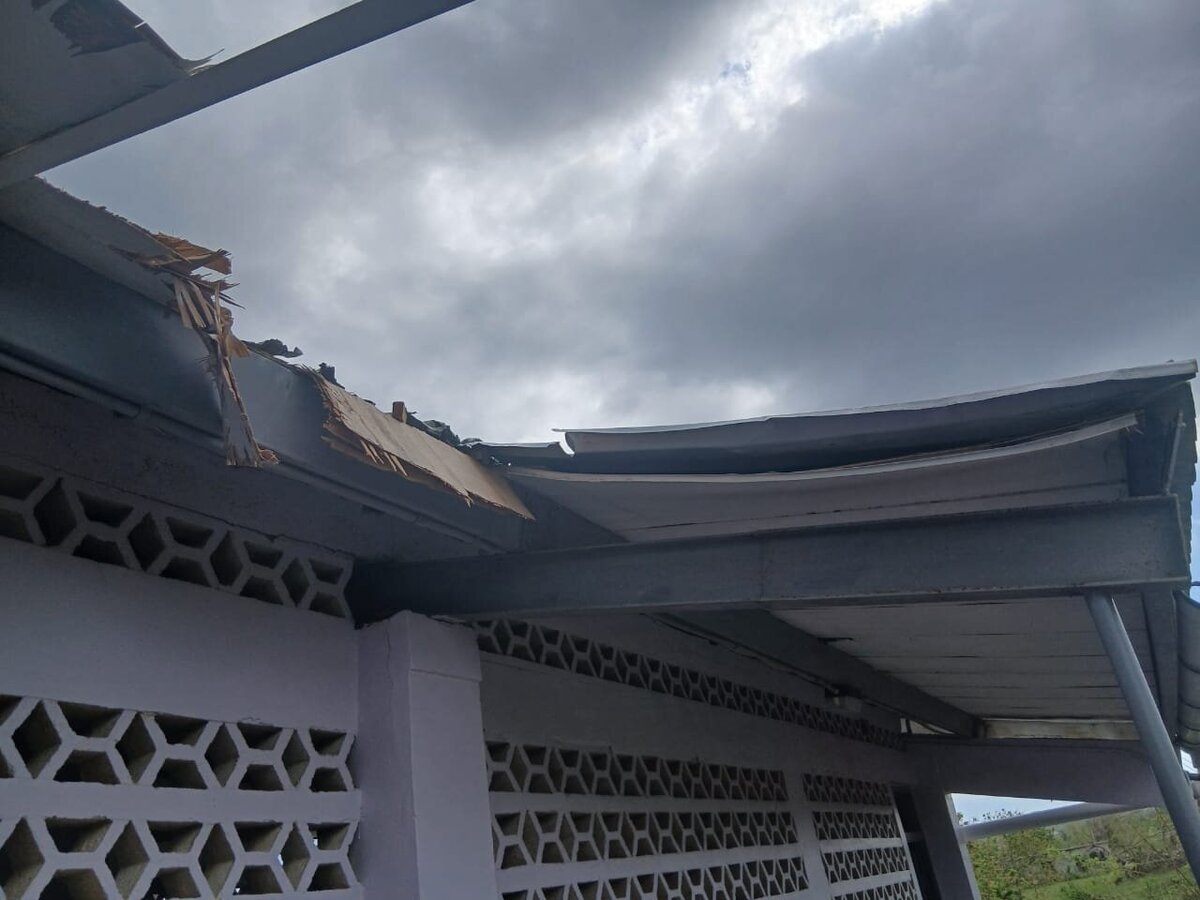 Damaged overhang and cracked exterior wall at the school following Hurricane Melissa.