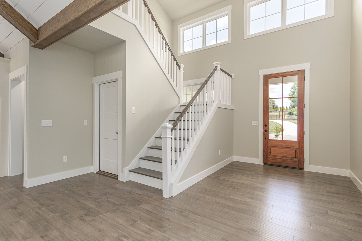 A home with hardwood floors and a staircase
