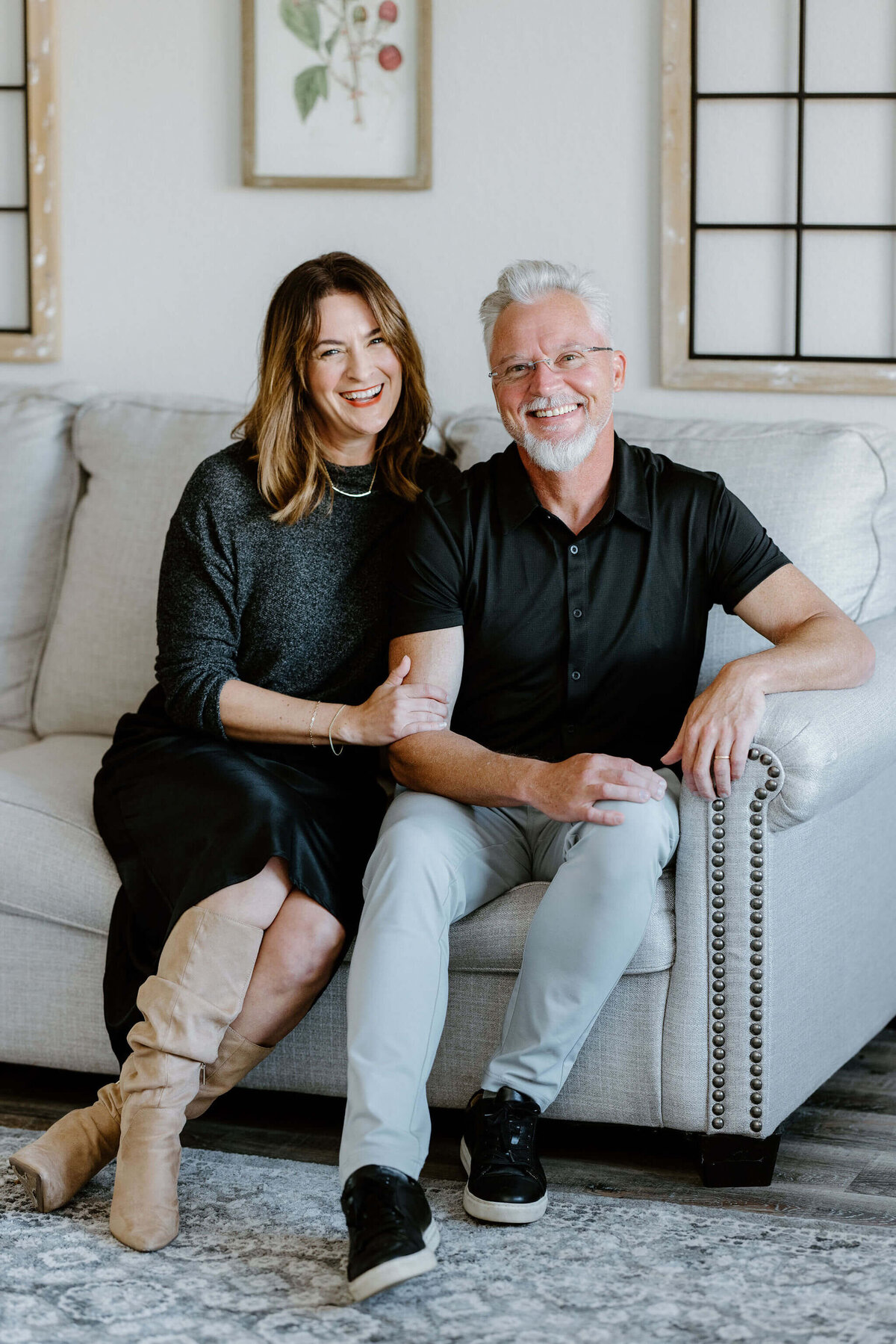 Lori Ivey State Farm Insurance agent candid professional headshot with husband on couch in office lobby