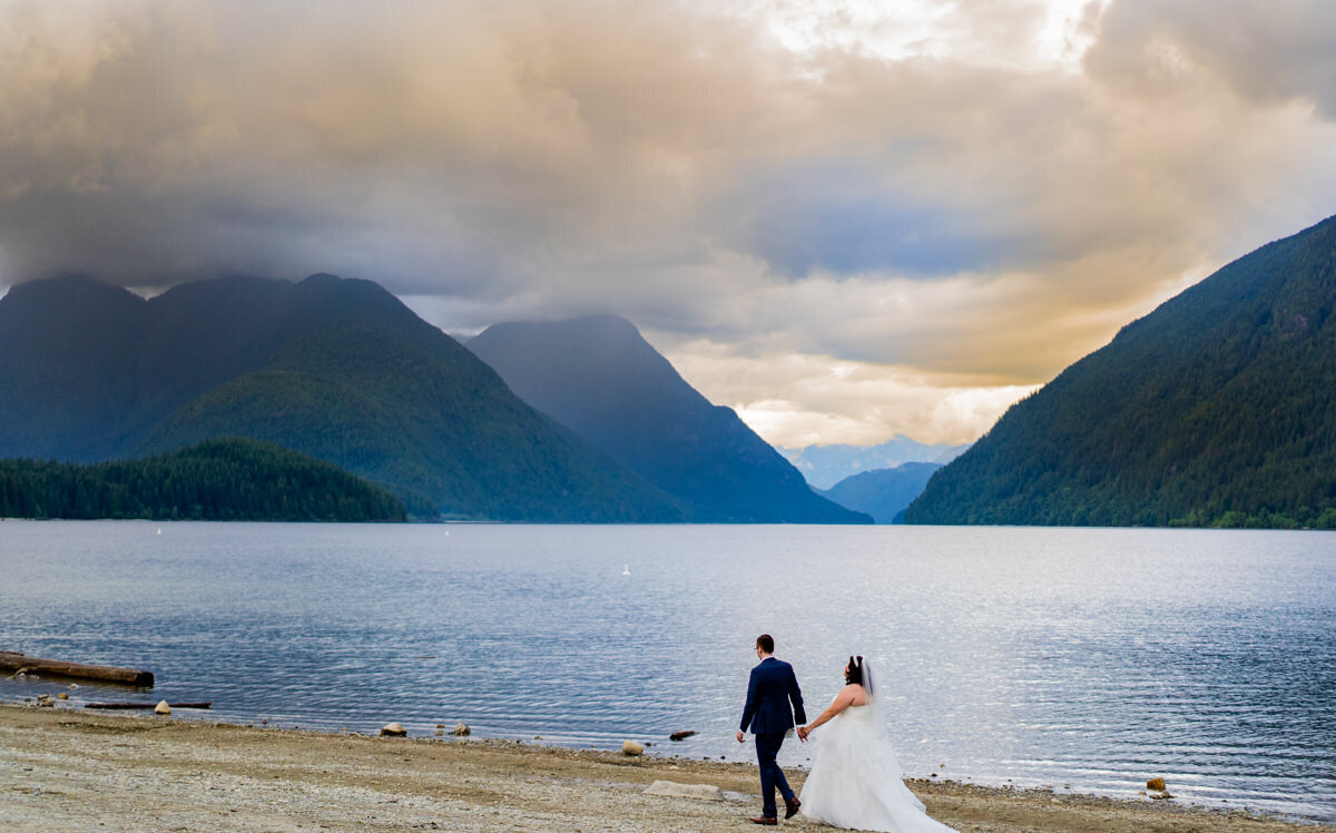 bride and groom walking along Alouette Lake