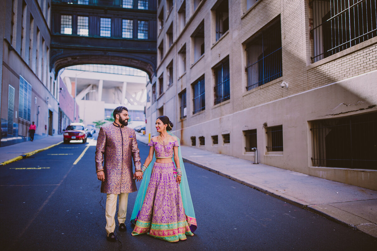 Indian bride and groom walking down the street in Hartford Connecticut during their sangeet