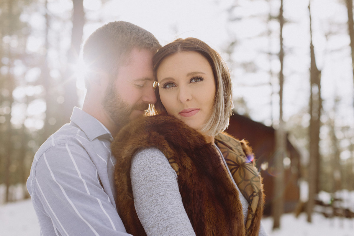 bride and groom cuddling close at sunset