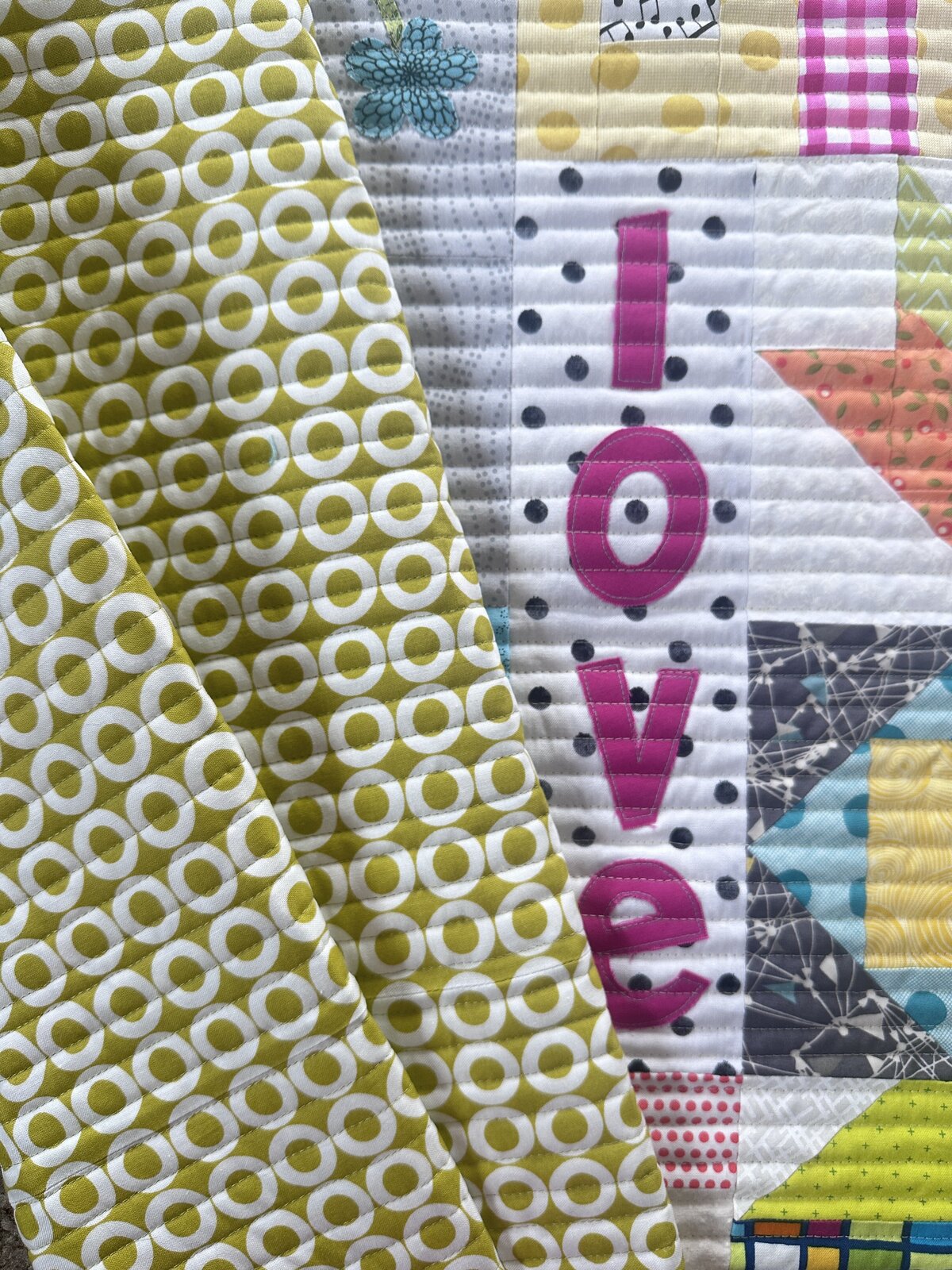 this modern love quilt features uniform straight line quilting.