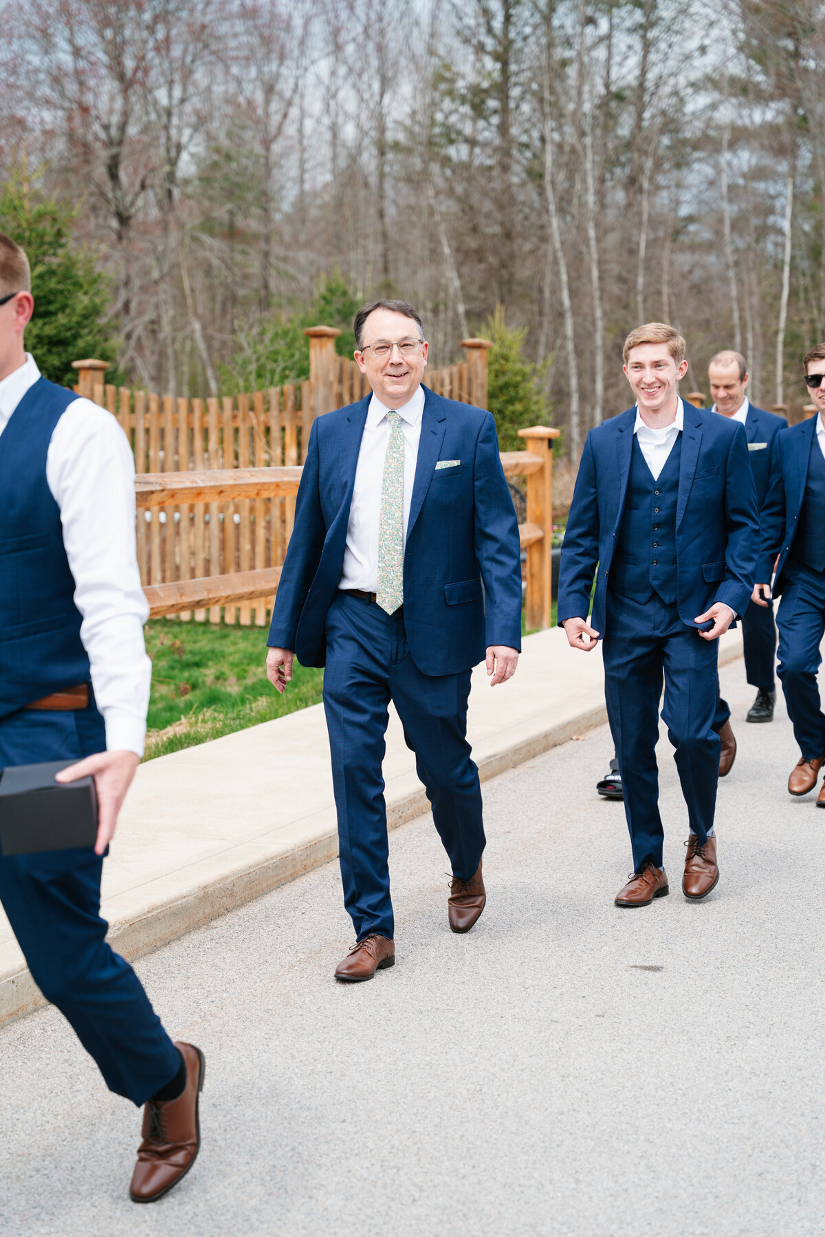 Candid moment of the groom adjusting his tie before the ceremony
