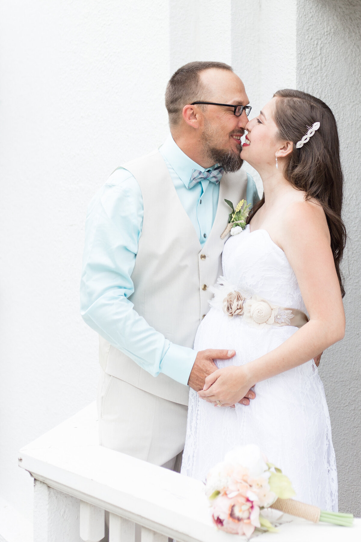 expectant couple joyfully embraces