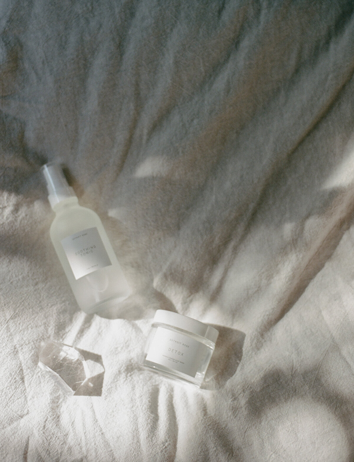 simple, artistic film branding photo for skincare company, minimal skincare, morning light, quartz crystal