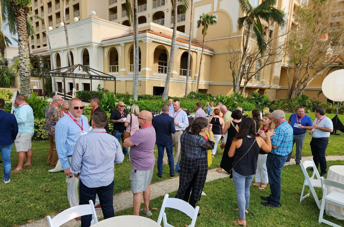 people mingling outside a resort at corporate event in florida