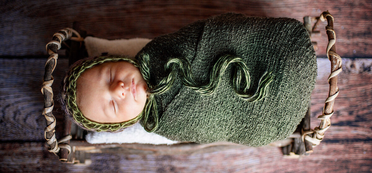 newborn  baby wrapped in green