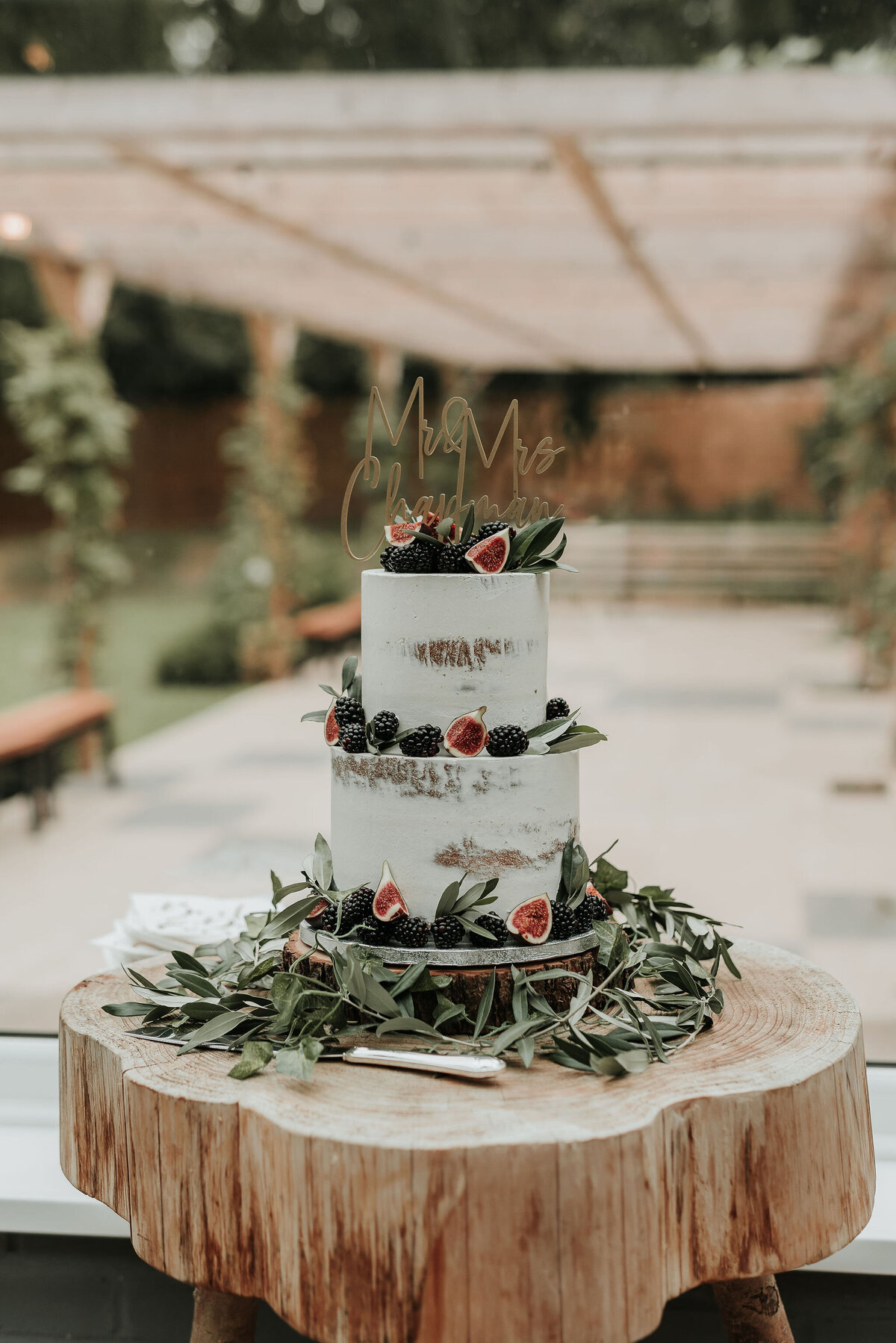 Rustic two tier wedding cake with figs and dark berries