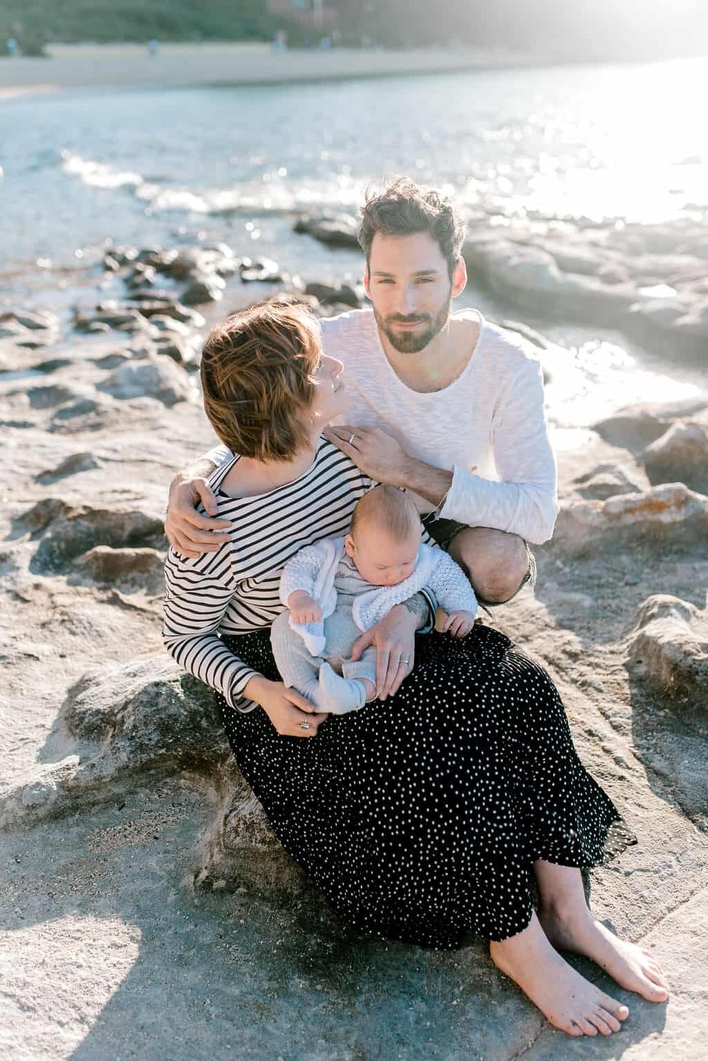 family-of-three-relaxing-at-sydney-beach-on-sunny-afternoon