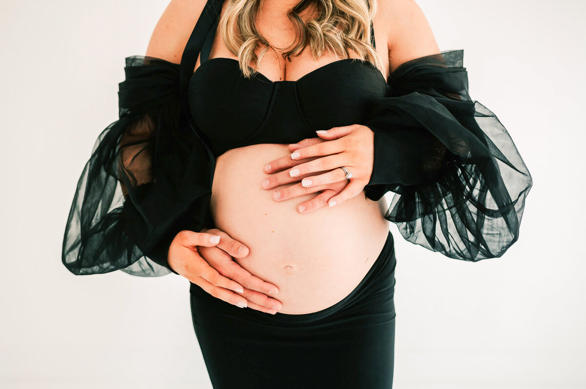 close up of pregnant baby bump with husband and wife hands during Springfield MO Maternity photography session