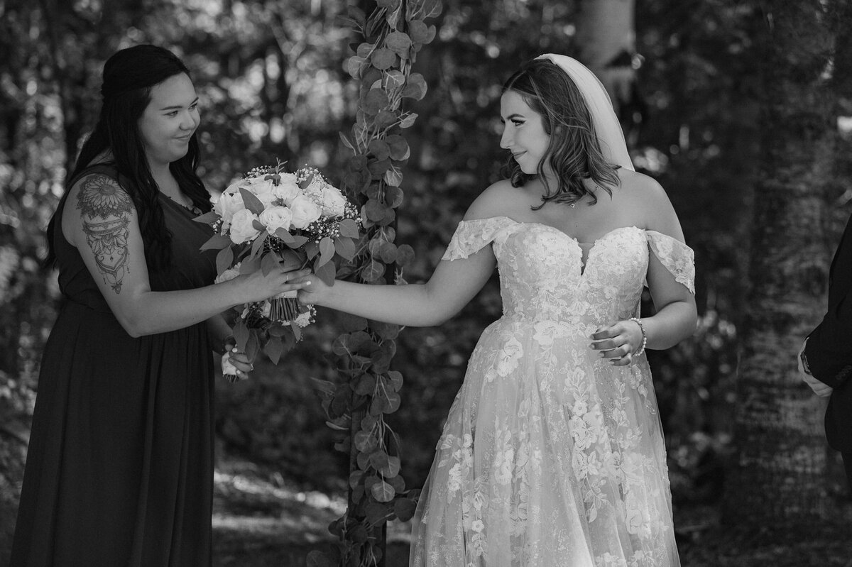 Bride passing off her bouquet at BC ceremony