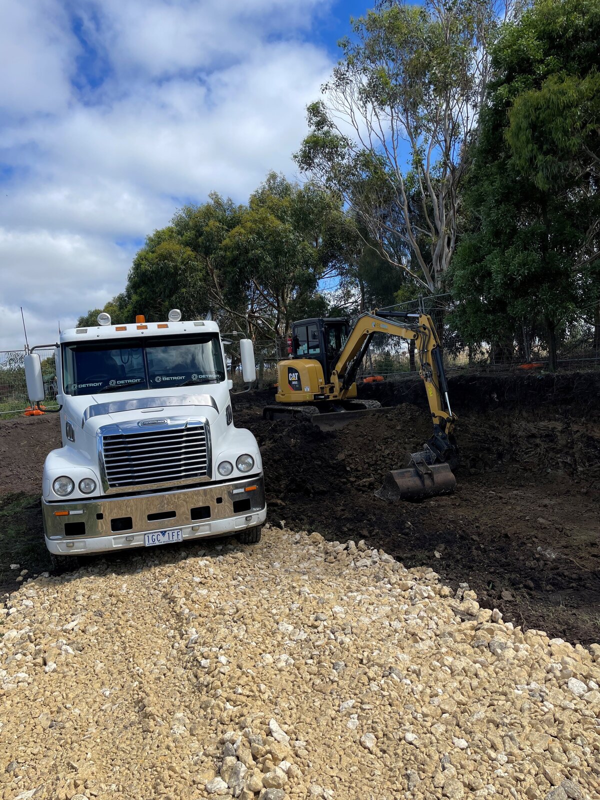 Excavator digging out backyard landscaping