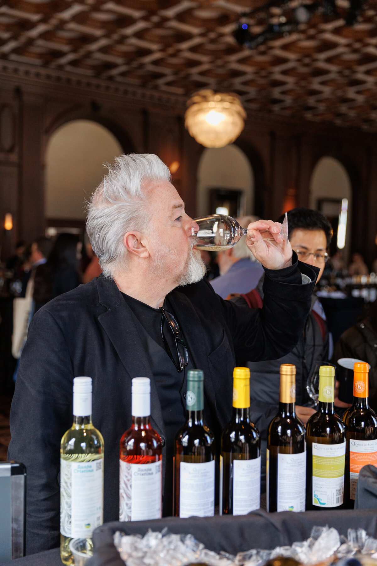 Older male drinking white wine