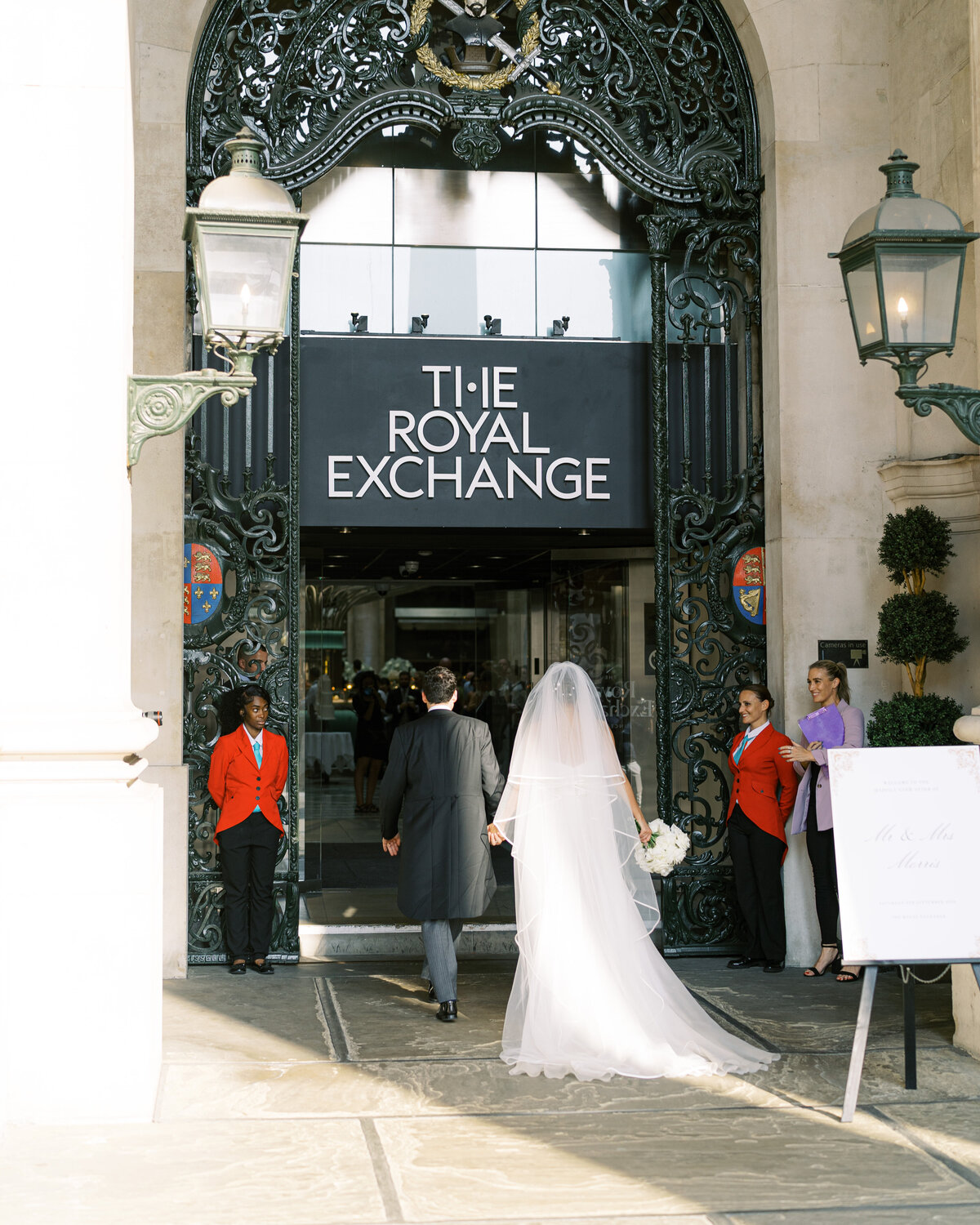 Bride and groom arriving for wedding reception at the Royal Exchange wedding venue