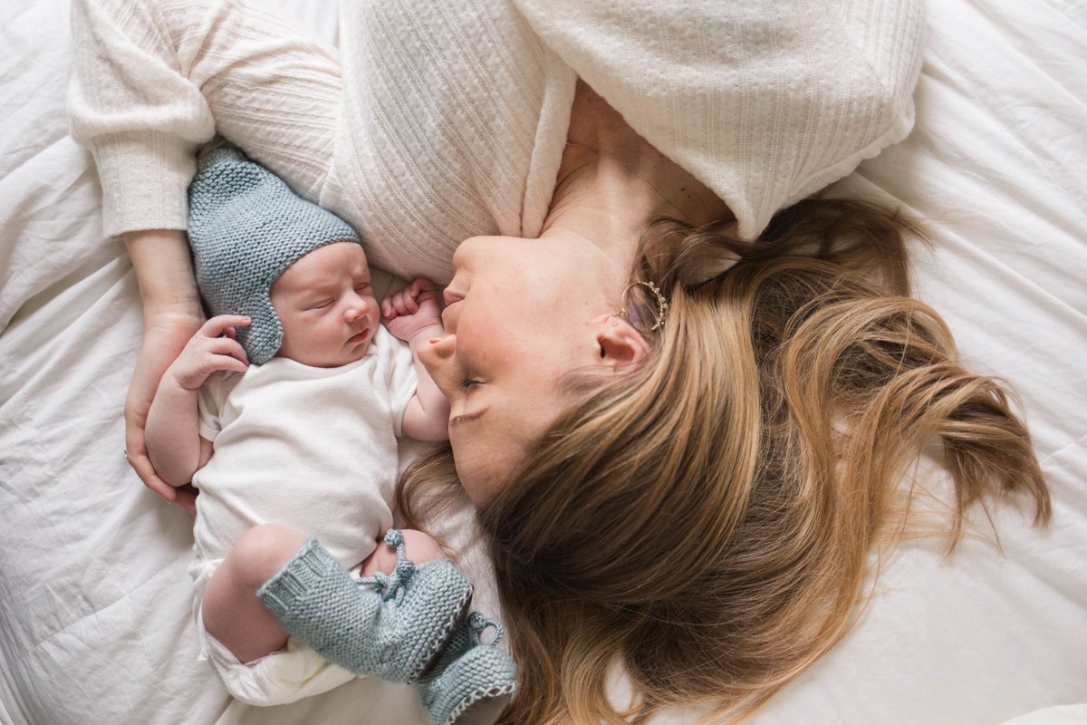 mother snuggling son during their lifestyle newborn session in Cincinnati, OH