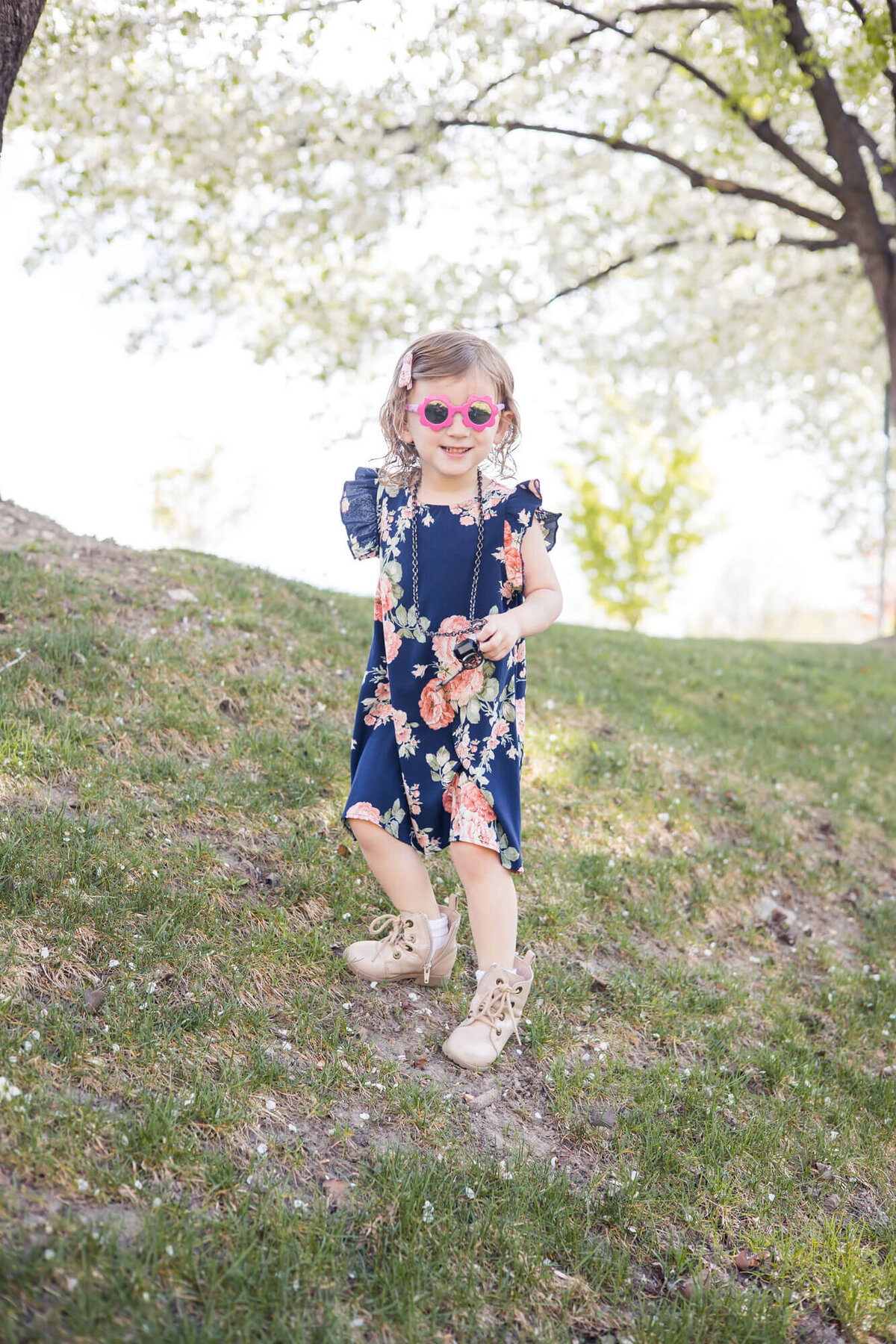 a toddler girl in a blue flowered dress