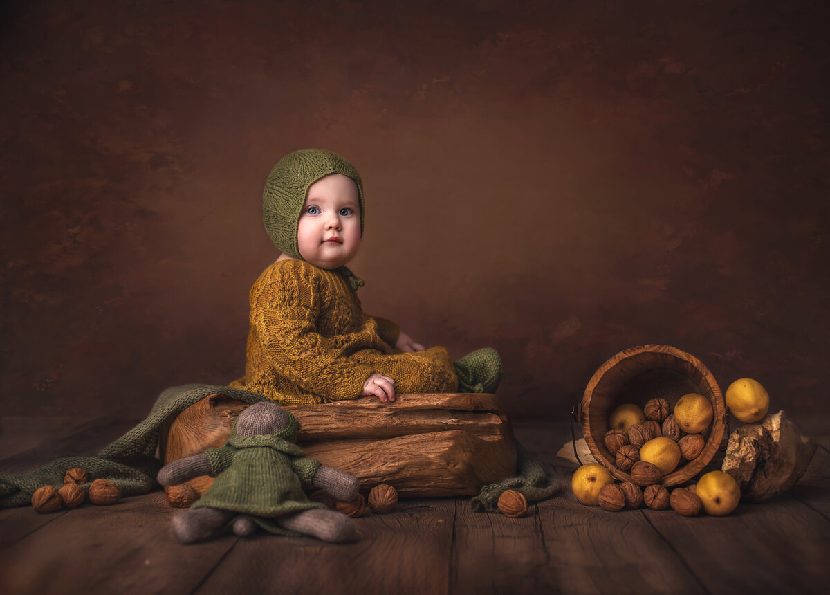 Six-month-old baby in creative lemon-themed setup with warm brown tones – Ottawa milestone photography session