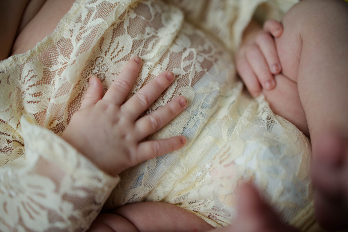 Close up of baby girl's hand on her tummy