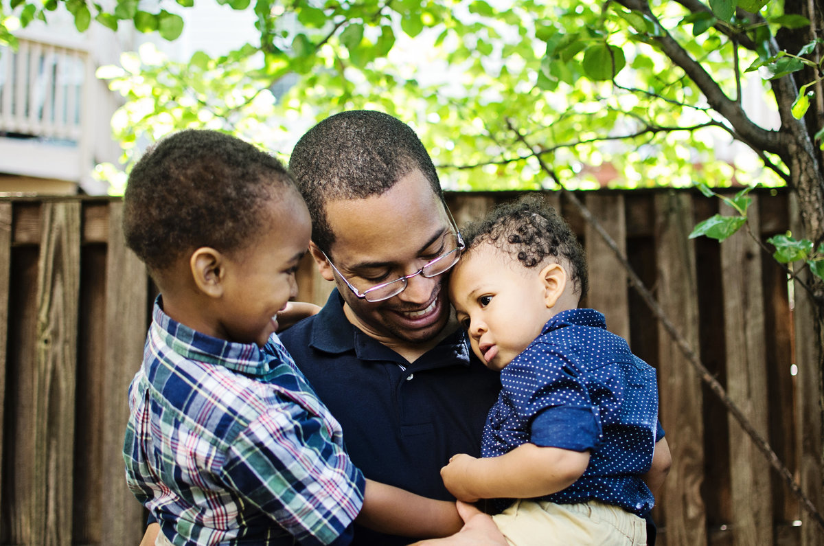 Portrait of a father and his sons taken in a lifestyle session at their home by Sarah Alice Photography