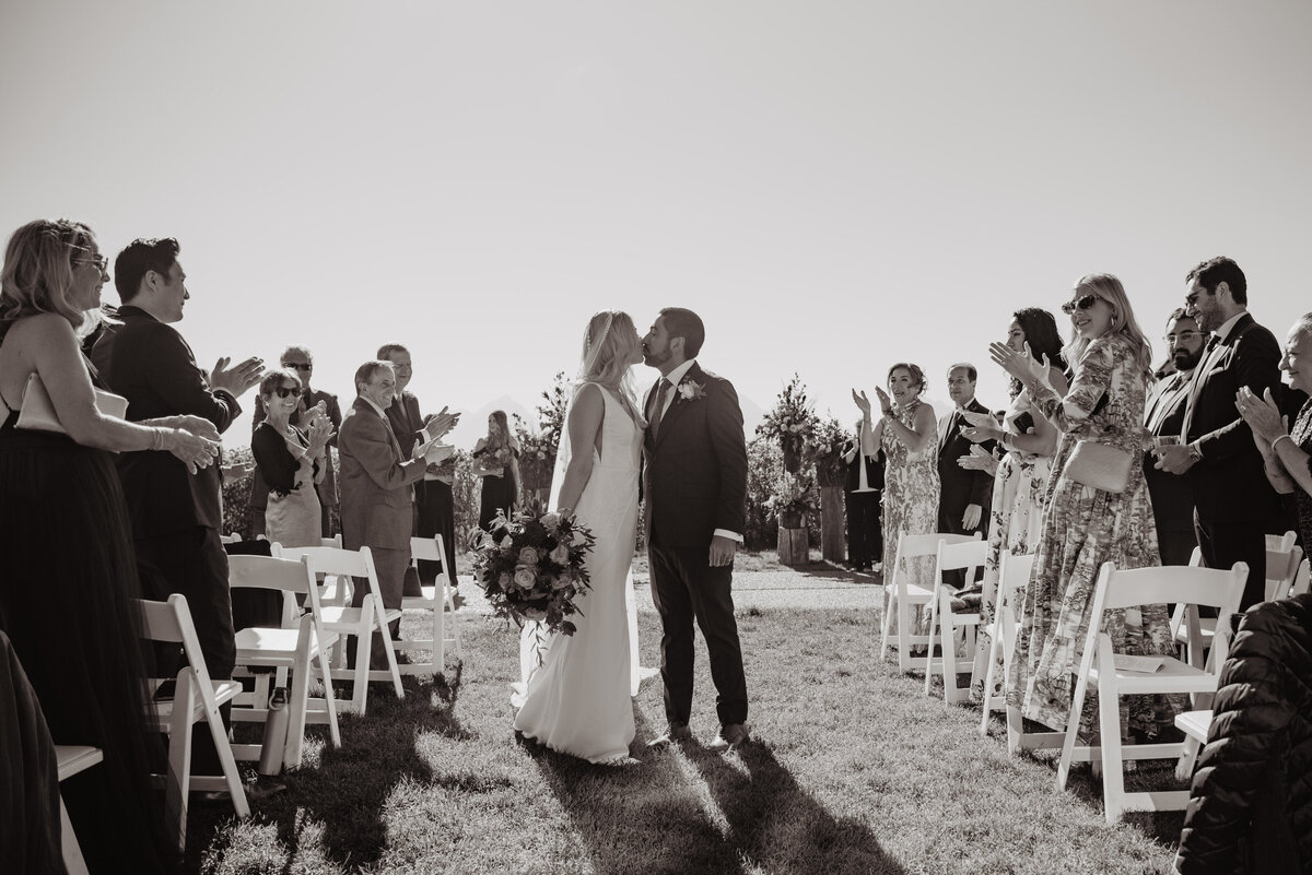 Photographers Jackson Hole capture couple kissing as they leave ceremony