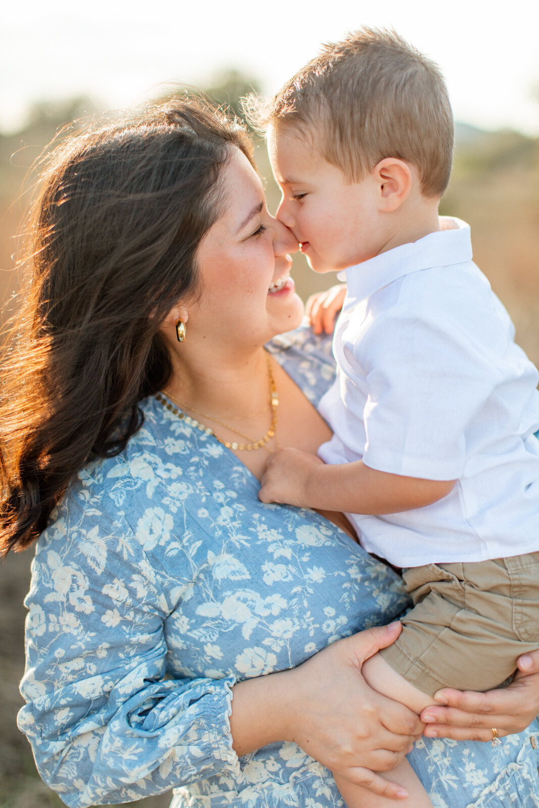 Maternity photo of a pregnant woman holding her young son, photographed by San Antonio family photographer Sara James.