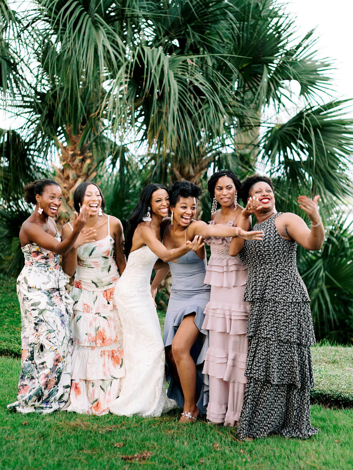 The bride, together with her bridesmaids, are outdoors in Montage at Palmetto Bluff. Destination Image by Jenny Fu Studio