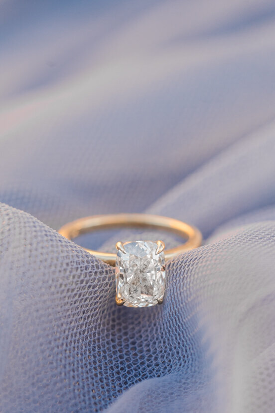 engagement-ring-on-blue-material