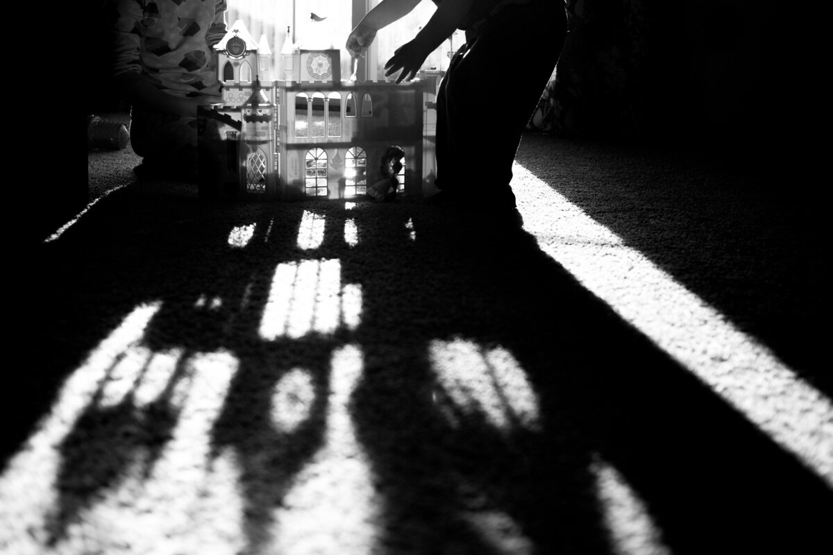 deep black and white shadows on floor by castle toy
