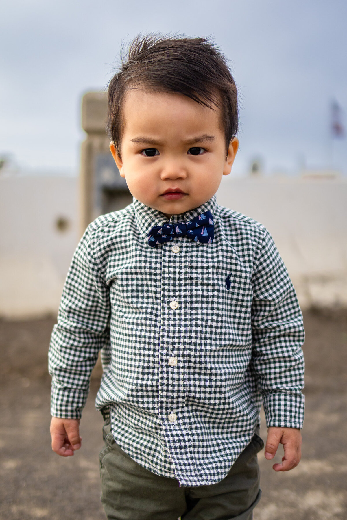 Young boy in checkered shirt and bow tie posing for Bay Area school photography lifestyle portrait – Ellobelle Photography