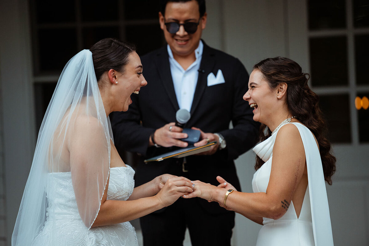 Brides laughing at the wedding alter