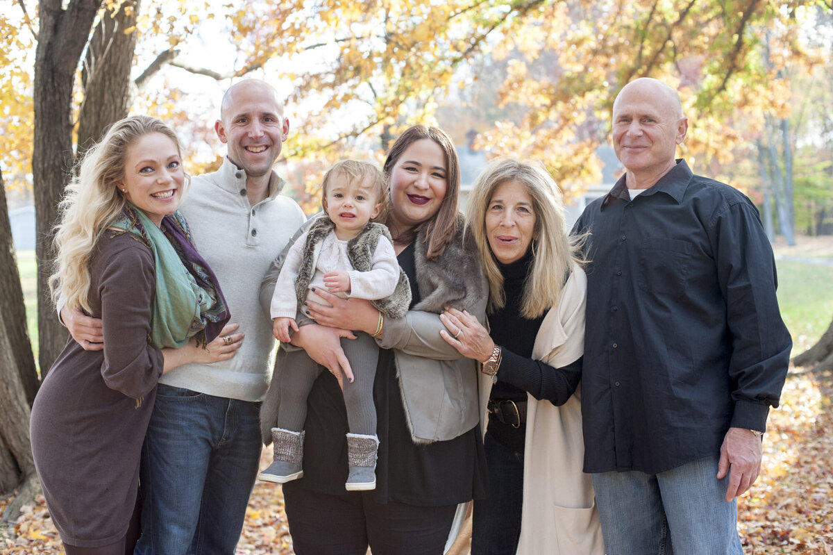 A family all standing together and smiling 