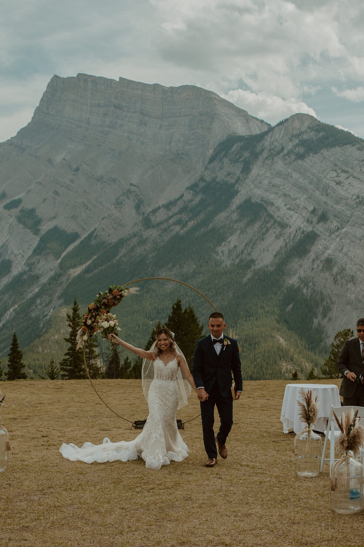 just married couple walking down aisle in Banff National Park