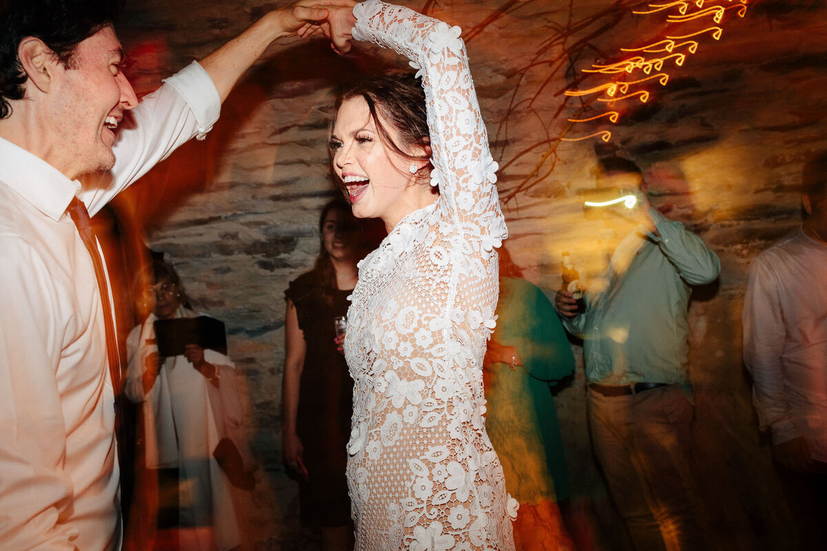 bride in lace reception dress dancing spinning laughing bride in lace reception dress dancing spinning laughing