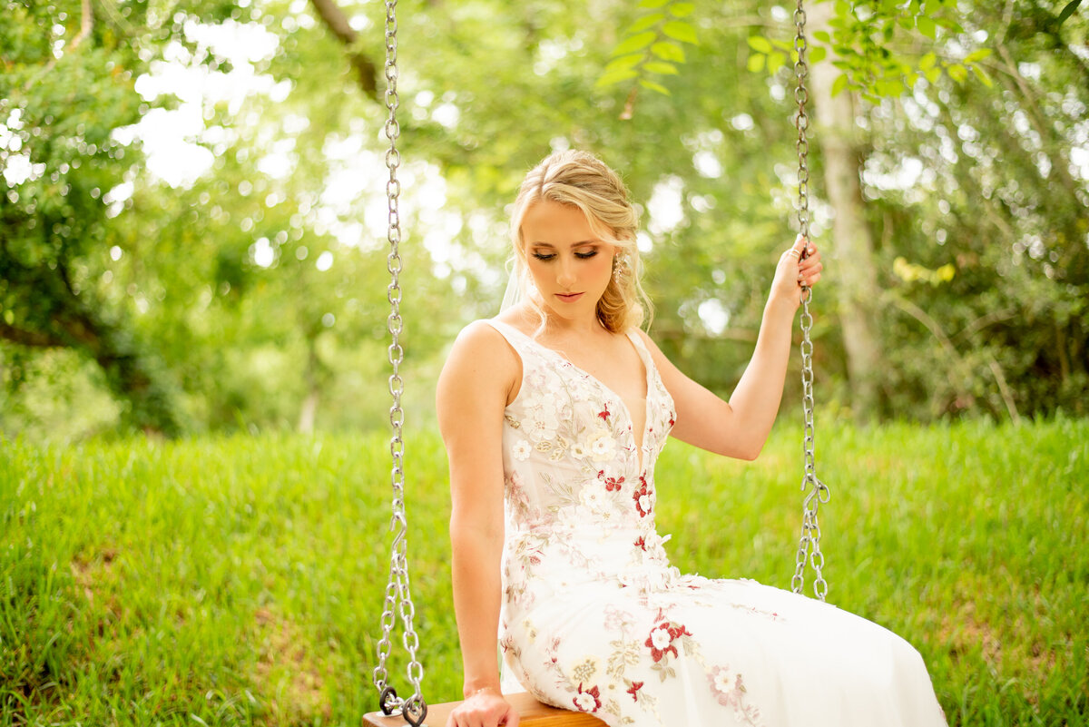 Capture the enchantment of a bride on a swing at The Springs Event Venue in Katy, Texas, as she embarks on her journey into forever with grace and beauty.