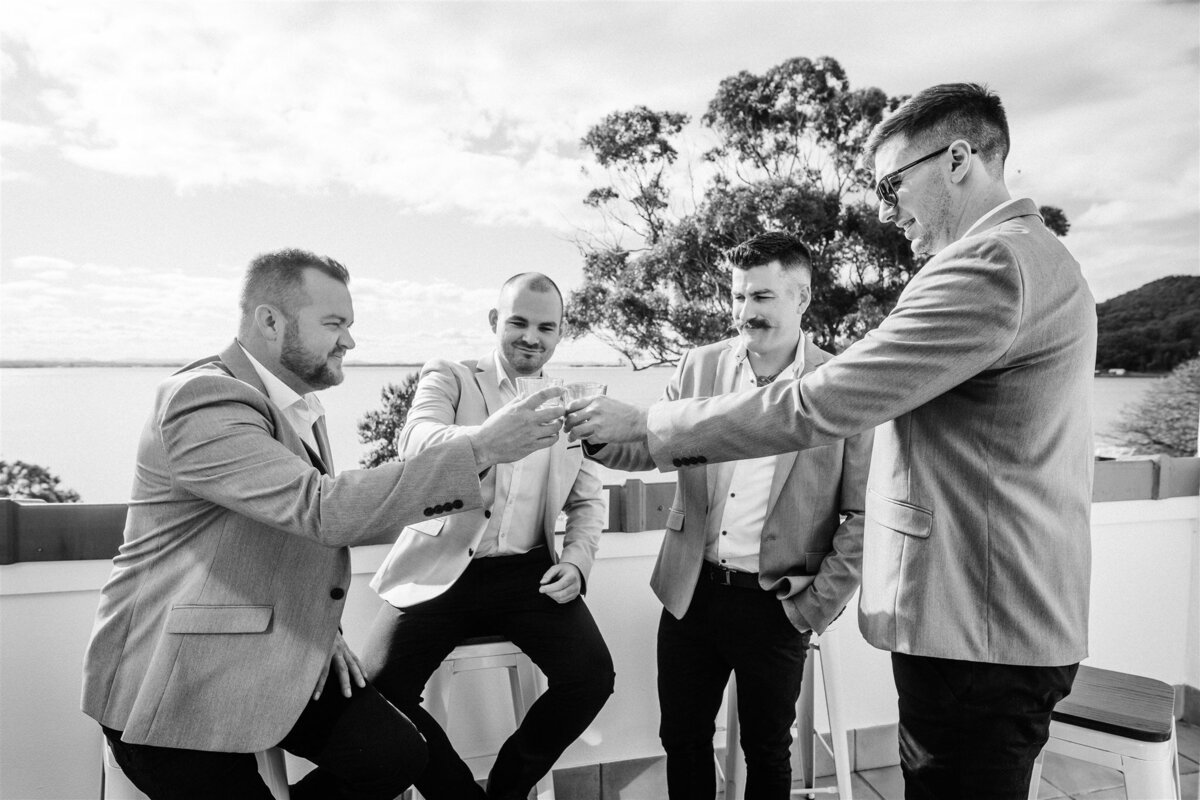 Cory together with his groomsmen are having fun and having a drink