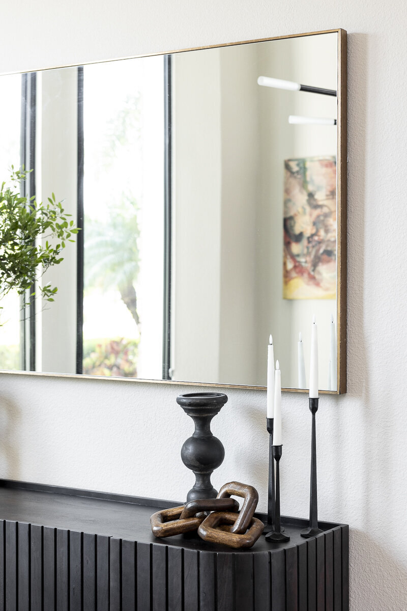 dewine design orlando interior designer windermere full home renovation square wall mirror and black candles on table